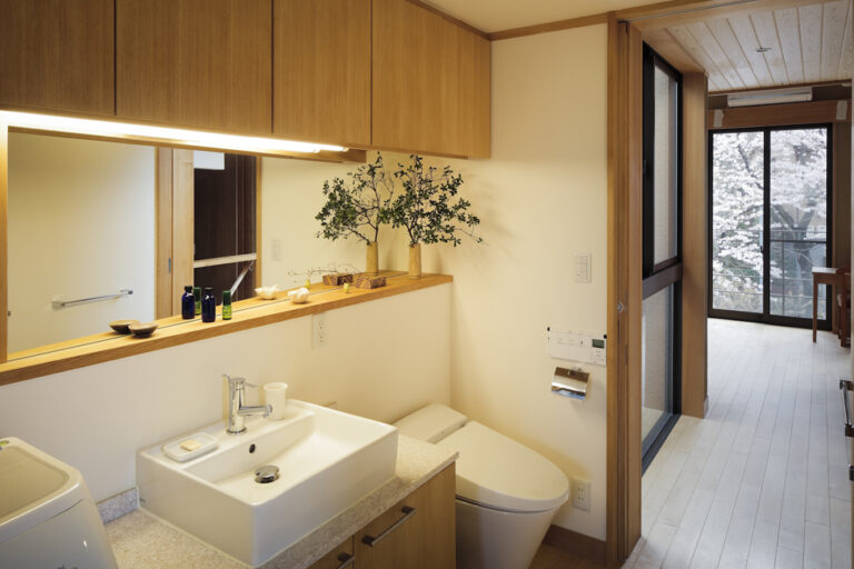 大きな鏡が光を柔らかく反射させ、奥行きをつくる。
清潔感と広がりを感じるシンプルな水まわり。